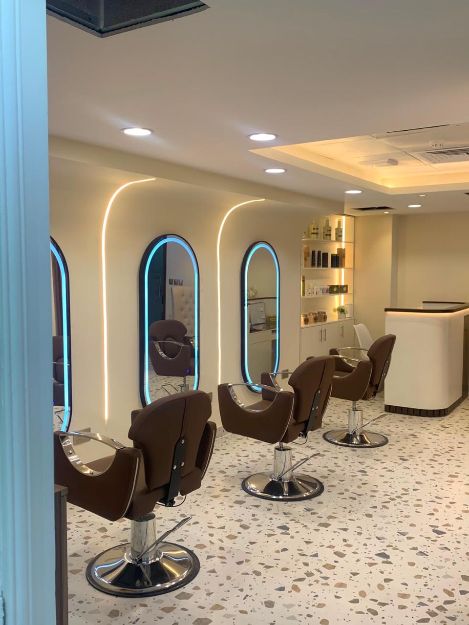 Hair styling area with salon chairs and illuminated mirrors at Magic Princess Salon